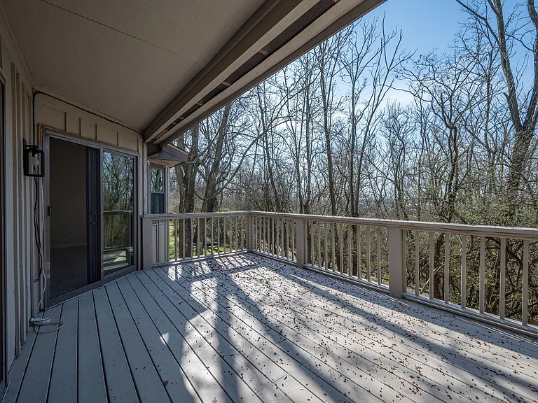 Upper level deck with wooded private backyard