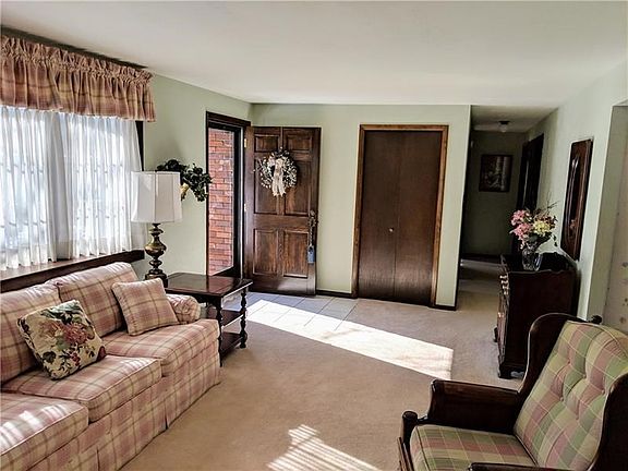The ceramic tile entry leads to the formal living room that features a bay window.