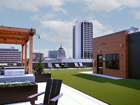 7th floor rooftop greenspace w/ fire pit and grilling area.