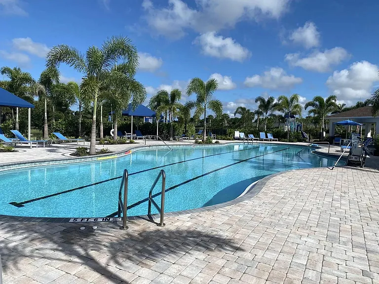 Pool area includes a kids splash pad, playground, sand volleyball court, picnic area.