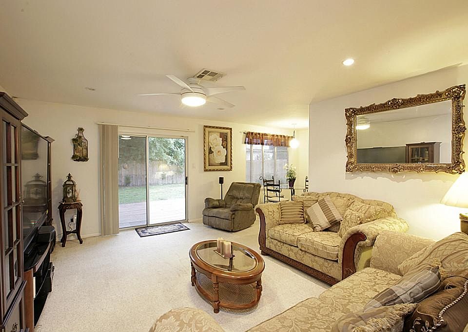 The living room has berber carpet, updated recessed lighting, a remote control ceiling fan, and an u