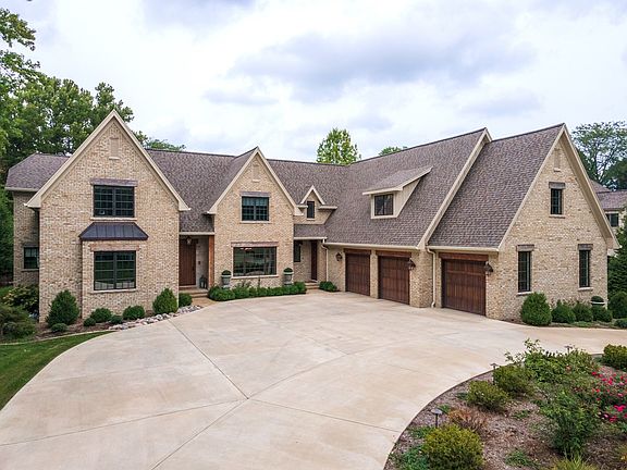 A circular driveway accommodates guest parking, and makes maneuvering in and out of the property a b