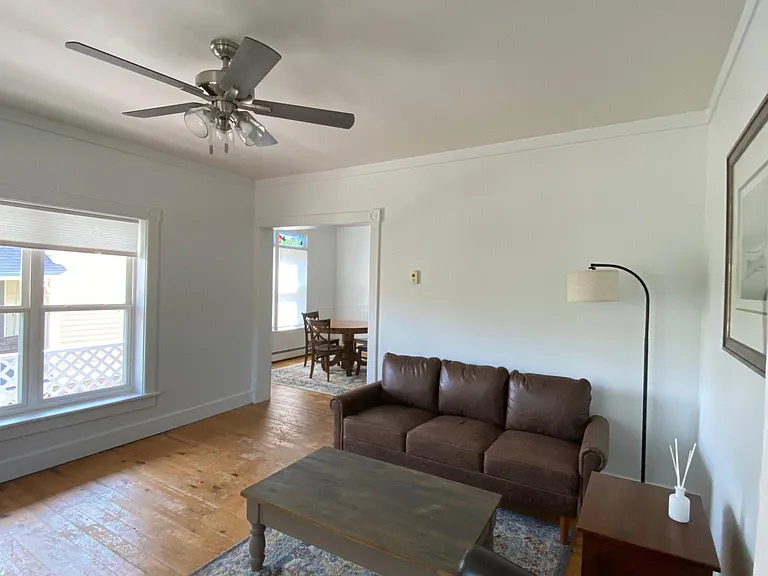 Living room with couch, chairs, and TV