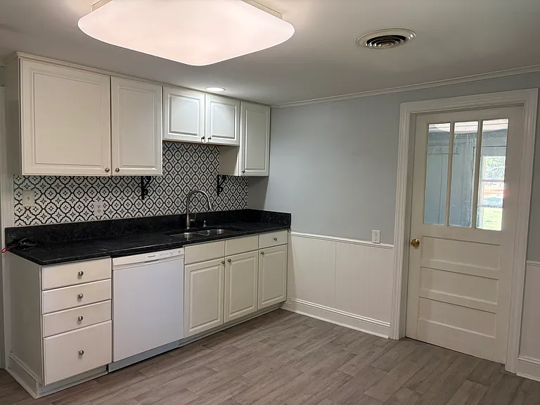 Kitchen with granite tops, 9"deep stainless sink and pull out stainless faucet.