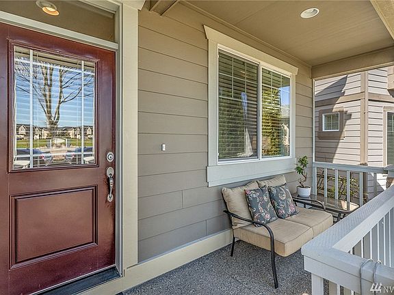 Large front windows and glass on the front door allow a lot of light into the entryway of the home.