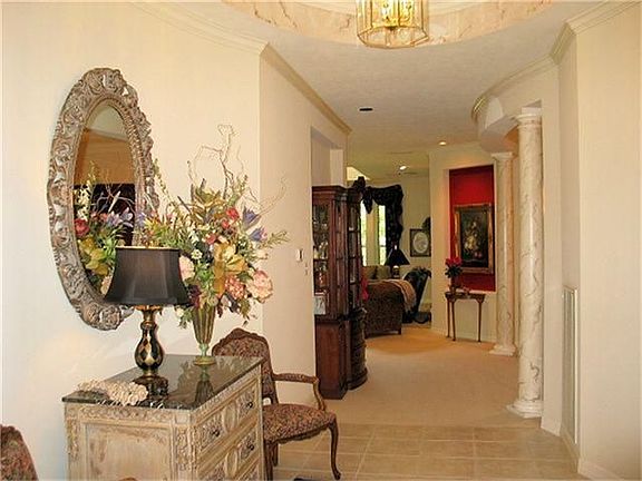 Dramatic Foyer Features An Elliptical Coffered Ceiling That Opens To A Private Guest Suite.