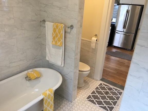 Old meets new with this claw foot tub and fully-tiled (separate) shower