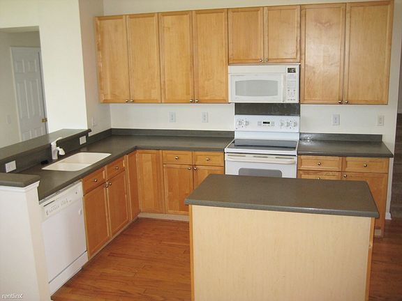 Spacious kitchen with Corian countertops.