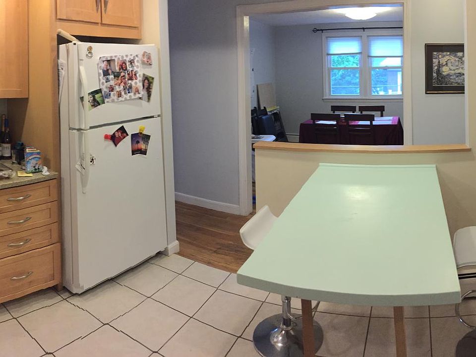 Large, bright Eat-In Kitchen recently updated with new cabinets, appliances (including gas stove, dishwasher, disposal, refrigerator and built-in microwave), Italian glass backsplash, granite countertops, tile floor and recessed lighting.