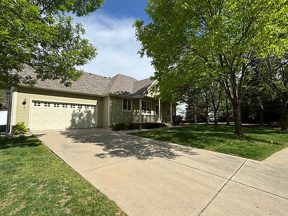 View of the driveway offering ample parking space for multiple vehicles, complemented by convenient additional street parking right outside the front door.