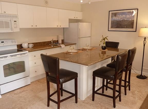 Kitche with all appliances, cookware, dishes, utensils, etc. dining island with high chairs