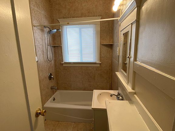 Bathroom with tile floors and shower. Tub / shower combo