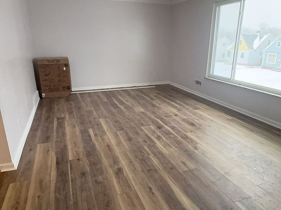 Spacious living room with large sun facing windows