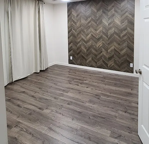 Spacious Master bedroom with accent wall & 8 ft windows facing green trees!