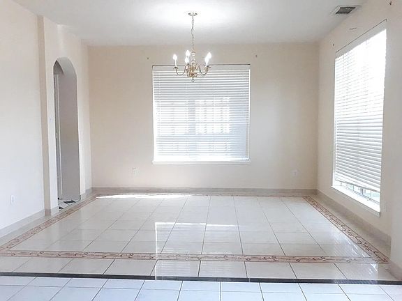 Formal dining room and entry door to kitchen. Lots of light