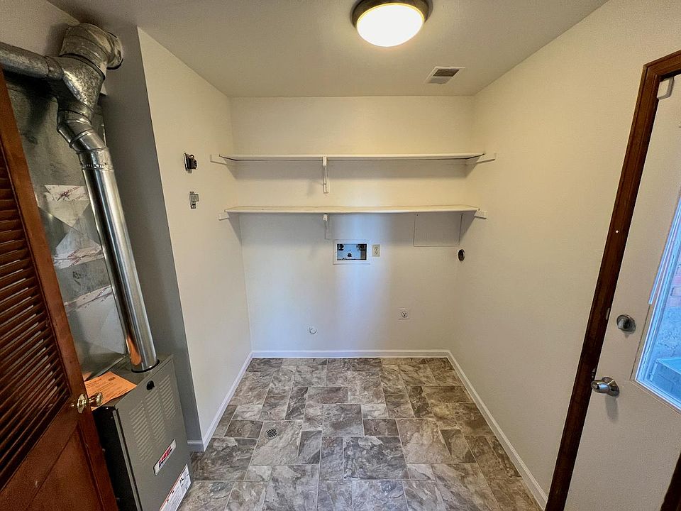 Washer/dryer hook ups off the kitchen, door to the outside.