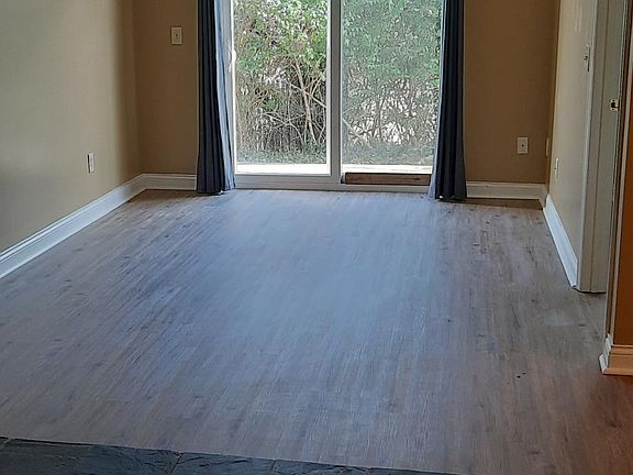 Living room with access to small patio.