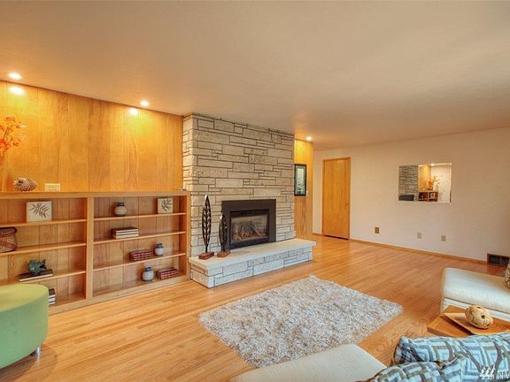 Attractive stone fireplace with hearth and built-in bookcase