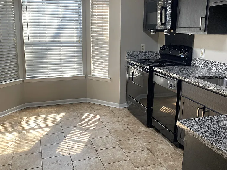 Kitchen with tile and black app