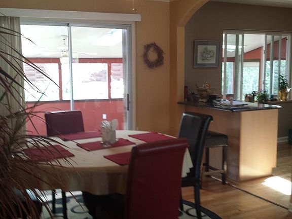 The dining room opens to the kitchen and large screened porch and backyard.