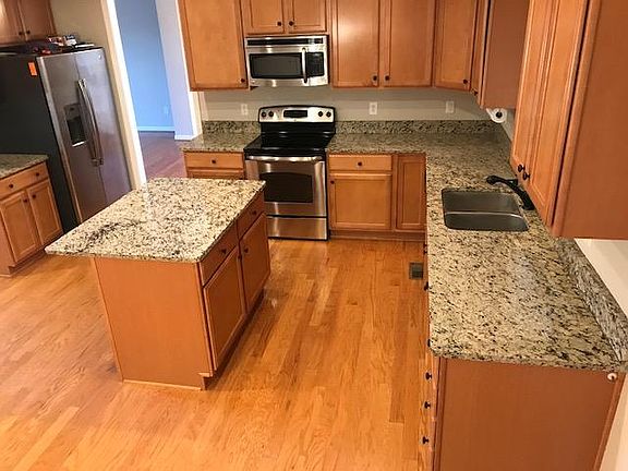 Spacious kitchen with island & granite countertops