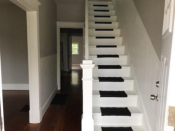 Beautiful stairway; lovely hardwood floors!