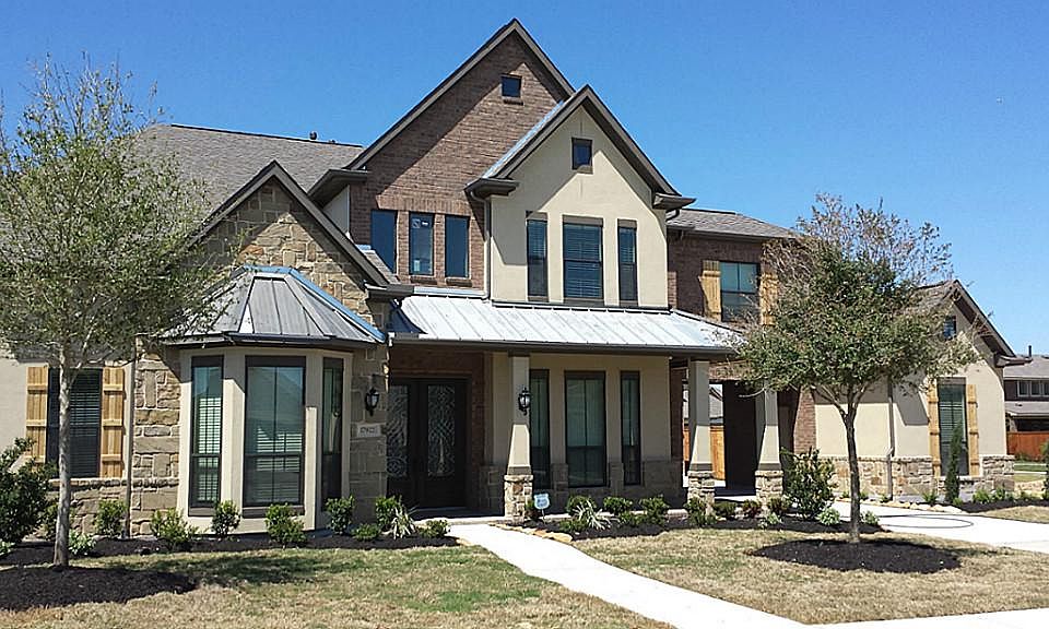 The brick, stone and stucco elevation is almost finished