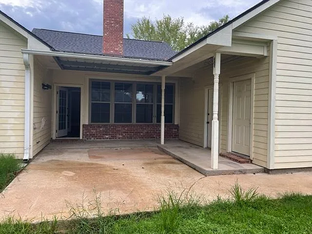 back patio door to the garage and door to the craft or tool shop