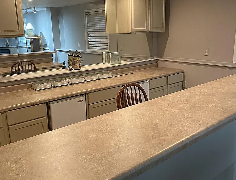 Huge Bar in Basement with 2 Mini Refrigerators.
Comes with beautiful fireplace, two white cabinet shelving units large desk area! It's a perfect basement for entertainment!