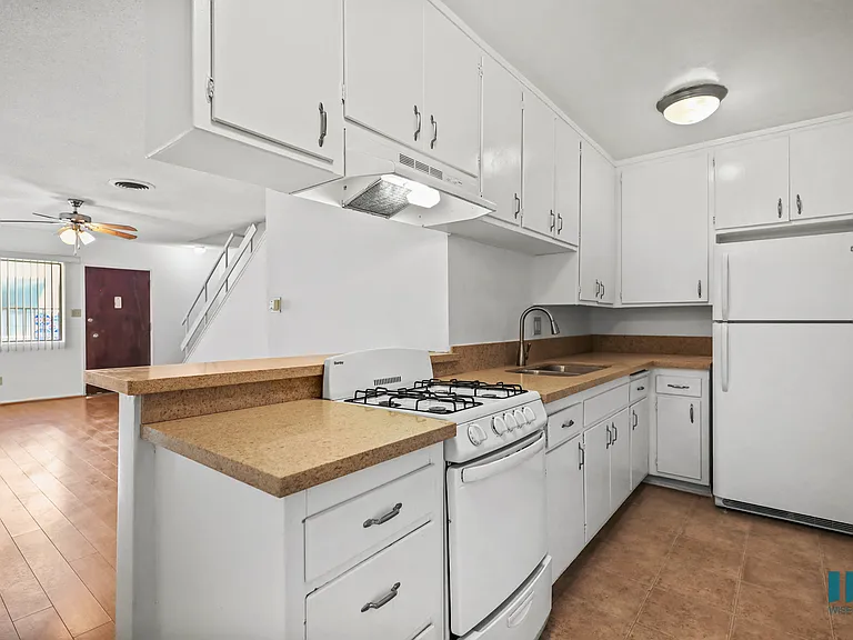 Kitchen with a Stove Oven, Refrigerator, and Ample Cabinet Storage