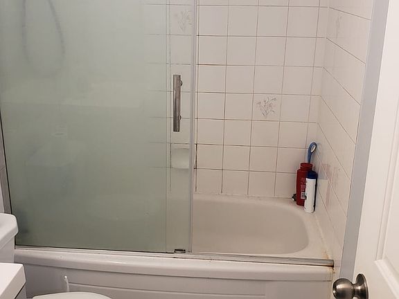 new bathroom with glass sliding door.