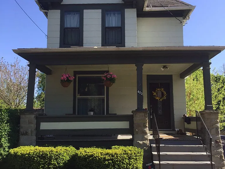 Covered front porch. Parking for 2 vehicles in side courtyard lot.