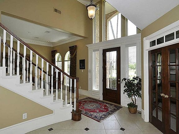 Home feels roomy the moment you enter! Extraordinary 20 foot foyer, etched glass, bright transoms & refinished walnut door. Marvelous neutral diagonal travertine floor & custom chandelier.