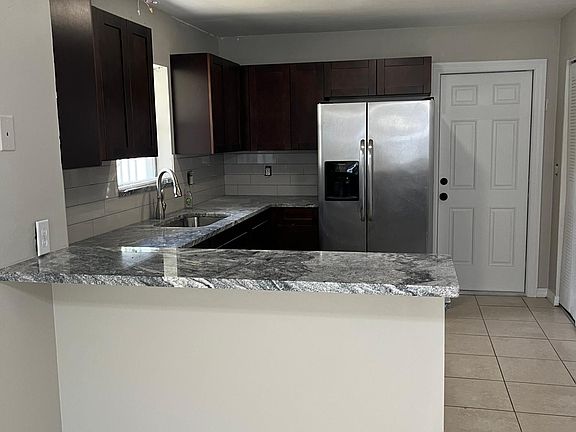 Remodeled kitchen with wood cabinets and granite countertops/ Stainless steel appliances