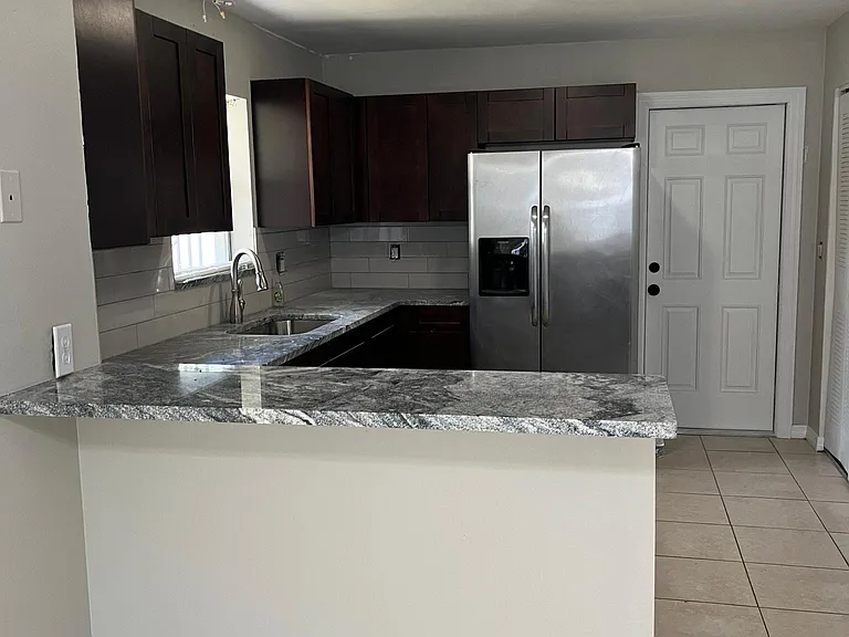 Remodeled kitchen with wood cabinets and granite countertops/ Stainless steel appliances