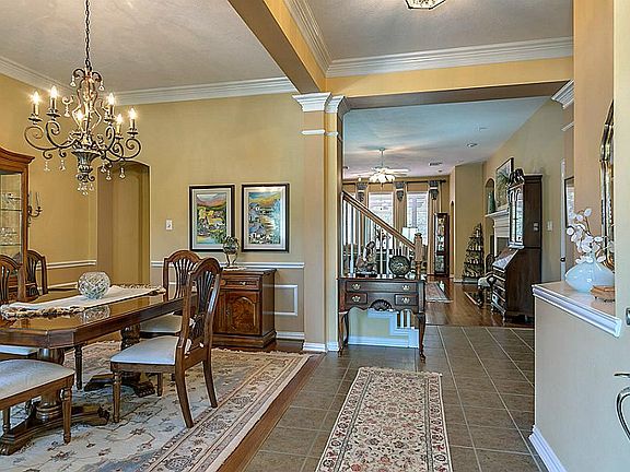 Open entry leads the large formal dining with wood floors.
