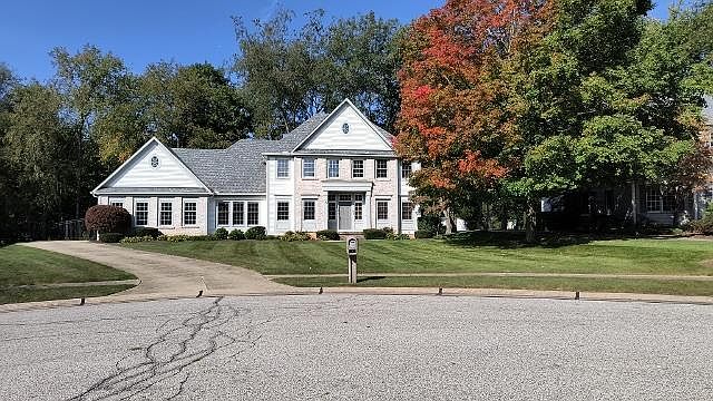 Situated on a cul-de-sac in an upscale community. White siding with light beige brick facade and gray trim. Multi-gray shingled roof new 2021. Cement driveway leads to 3-car garage. Bed and lawncare included. Fenced-in backyard.