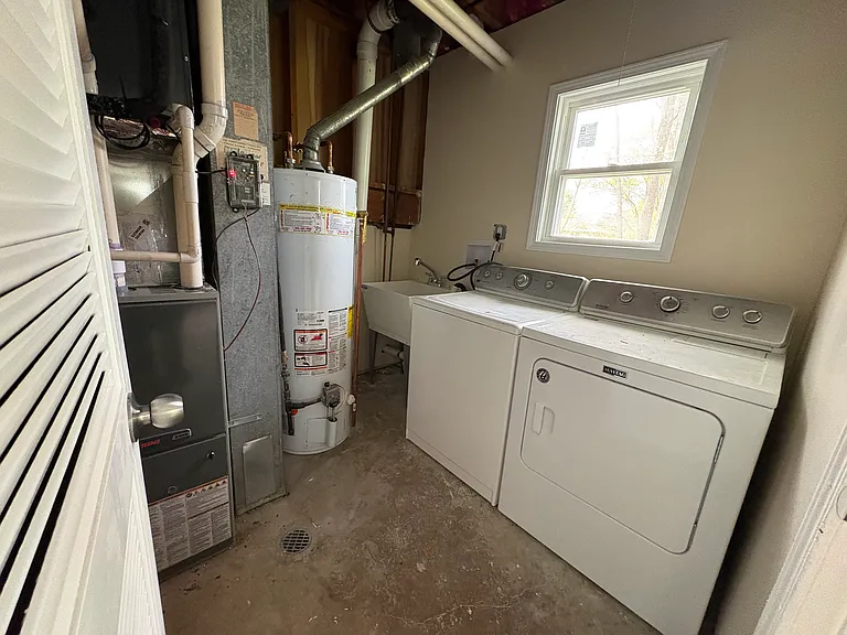 Laundry machines (washer and dryer) + utility sink located in mechanicals room