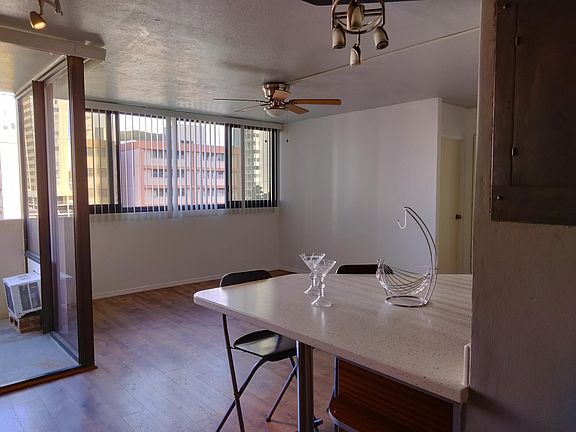 Living room furnished with sofa bed end tables and coffee table. Kitchen now has comfortable adjustable stools.