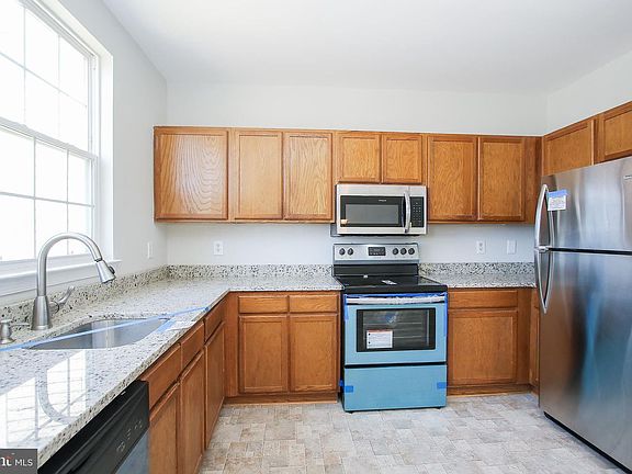 Kitchen, these cabinets have been repainted white.