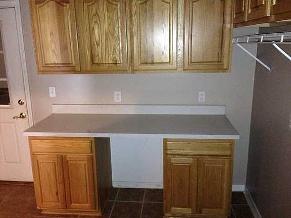 Laundry room with plenty of cabinets and closets for storage