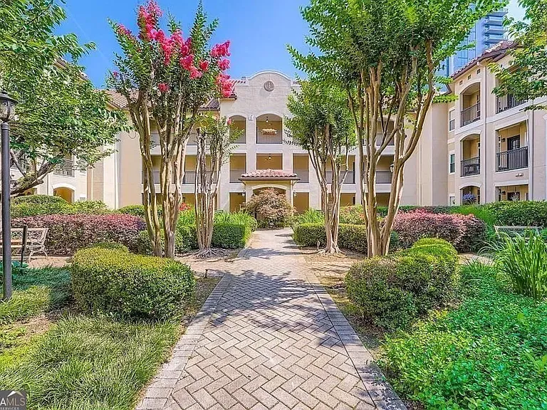 Lush, landscaped courtyard leading to unit