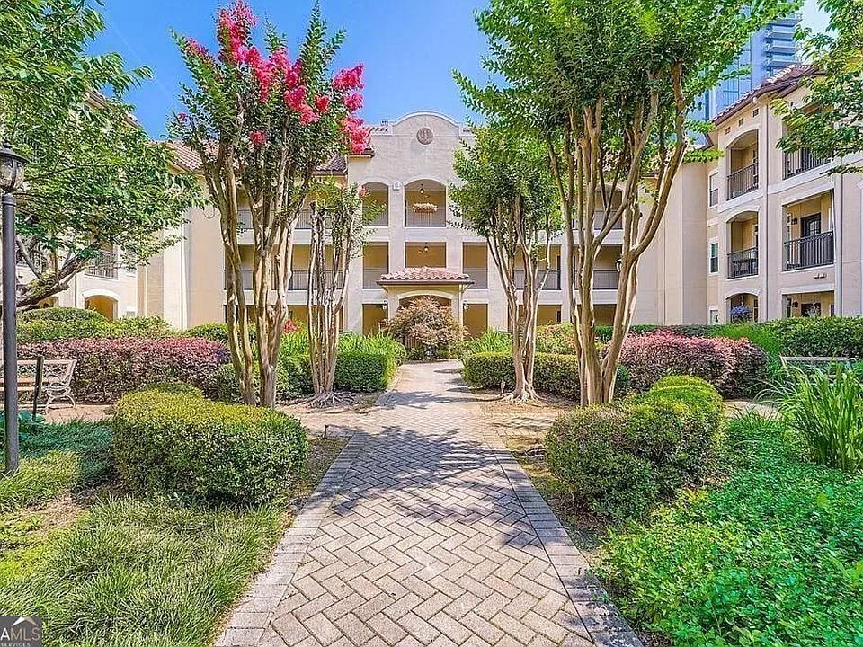 Lush, landscaped courtyard leading to unit