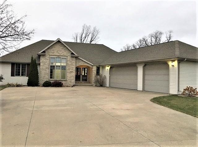 3 car attached garage with service door and no sidewalks to maintain!
