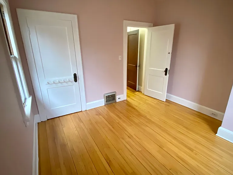 Bedroom 2 with closet and 2 large windows.