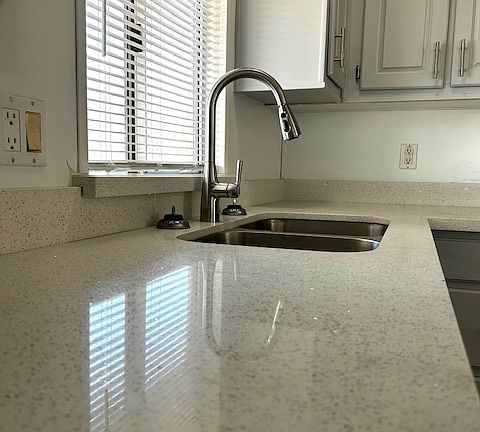 New quartz countertops, sink and faucet.
