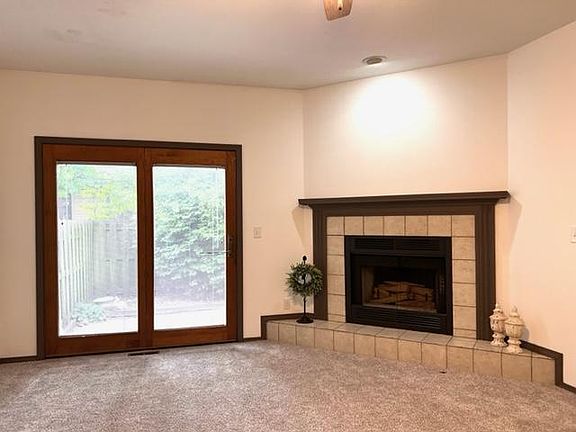 9' Step Down Great Room with a Wood Burning Fireplace and All New Carpeting/Padding