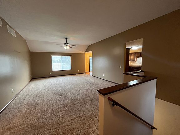 Open Living Room with neutral carpeting