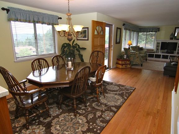 FIRST NOTICE ALL THE HARDWOODS. WHAT A GREAT AND WARM FEELING. DINING ROOM LOOKING INTO A GREAT REMODELED LIVING ROOM WITH LAKE VIEWS.
