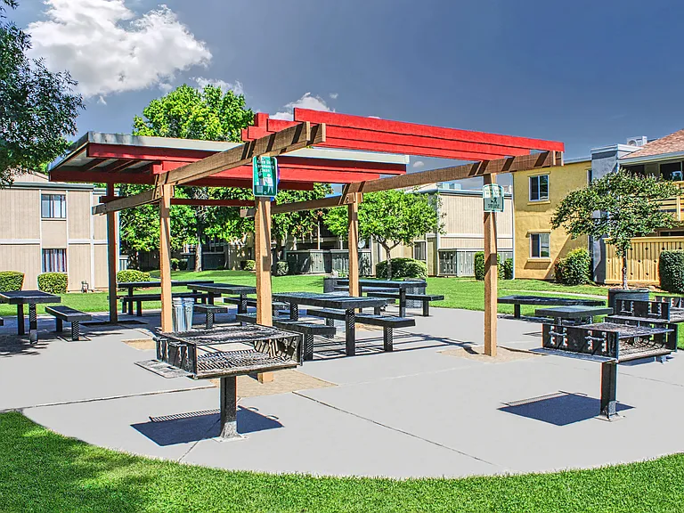 Outdoor BBQ and picnic area with covered seating.